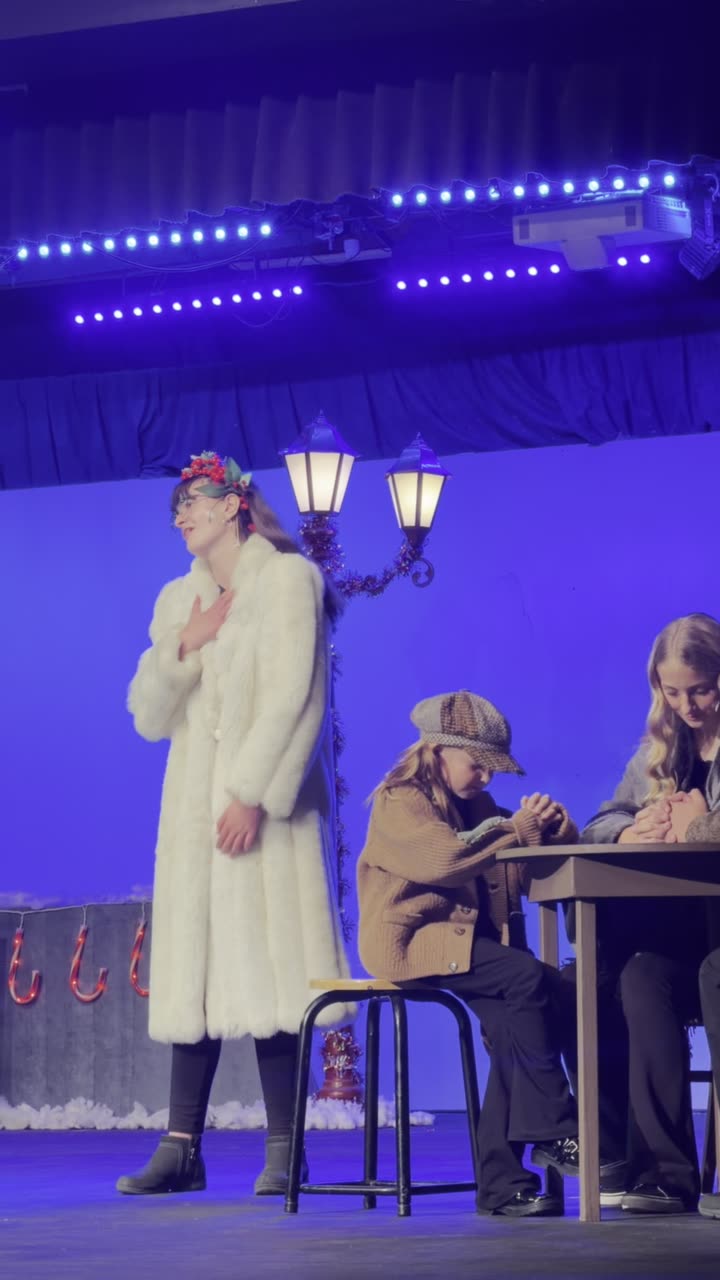 Stage scene: Wynter Pearce in a white fur coat as the Ghost of Christmas Present