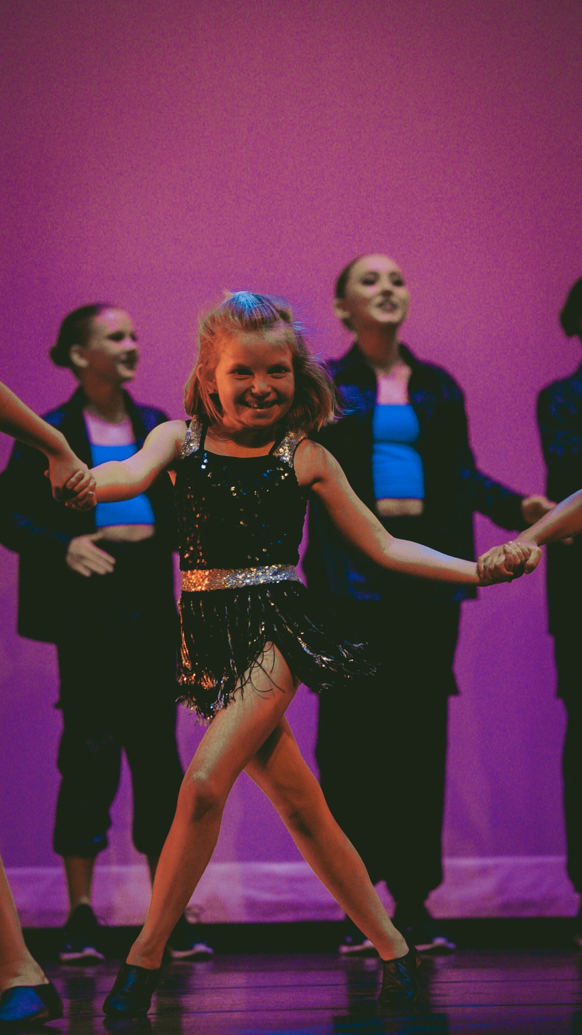 Wynter Pearce dancing on stage in a black sequinned costume